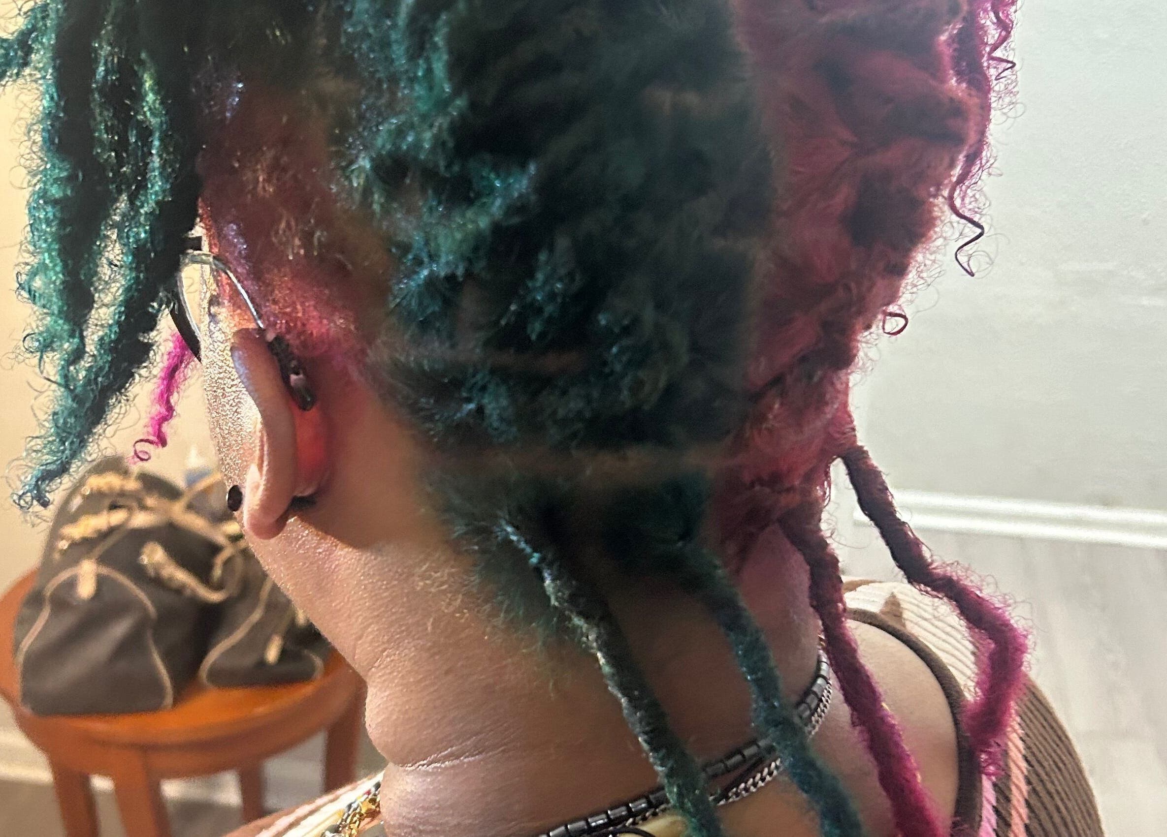 Colorful braided hairstyle at KountryStyles, Marietta, Georgia, US, showcasing unique flair and creativity.