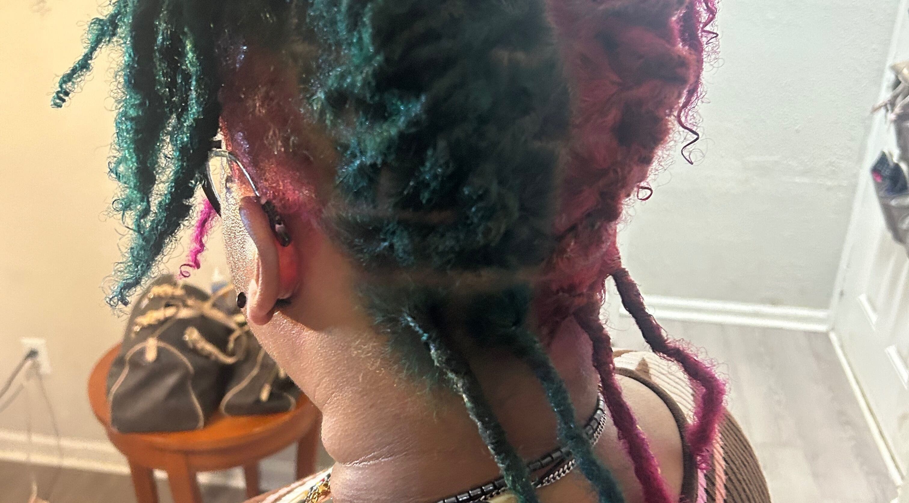Colorful braided hairstyle at KountryStyles, Marietta, Georgia, US, showcasing unique flair and creativity.