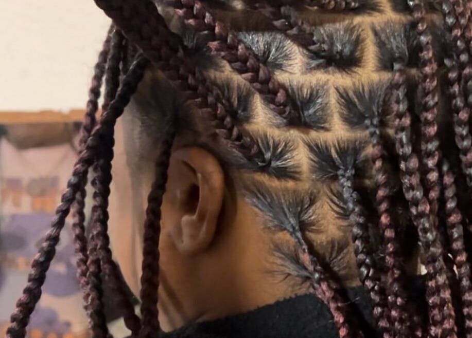 Detailed braided hairstyle at KountryStyles in Marietta, Georgia, US.