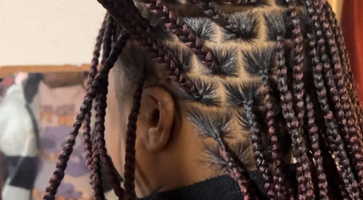 Detailed braided hairstyle at KountryStyles in Marietta, Georgia, US.