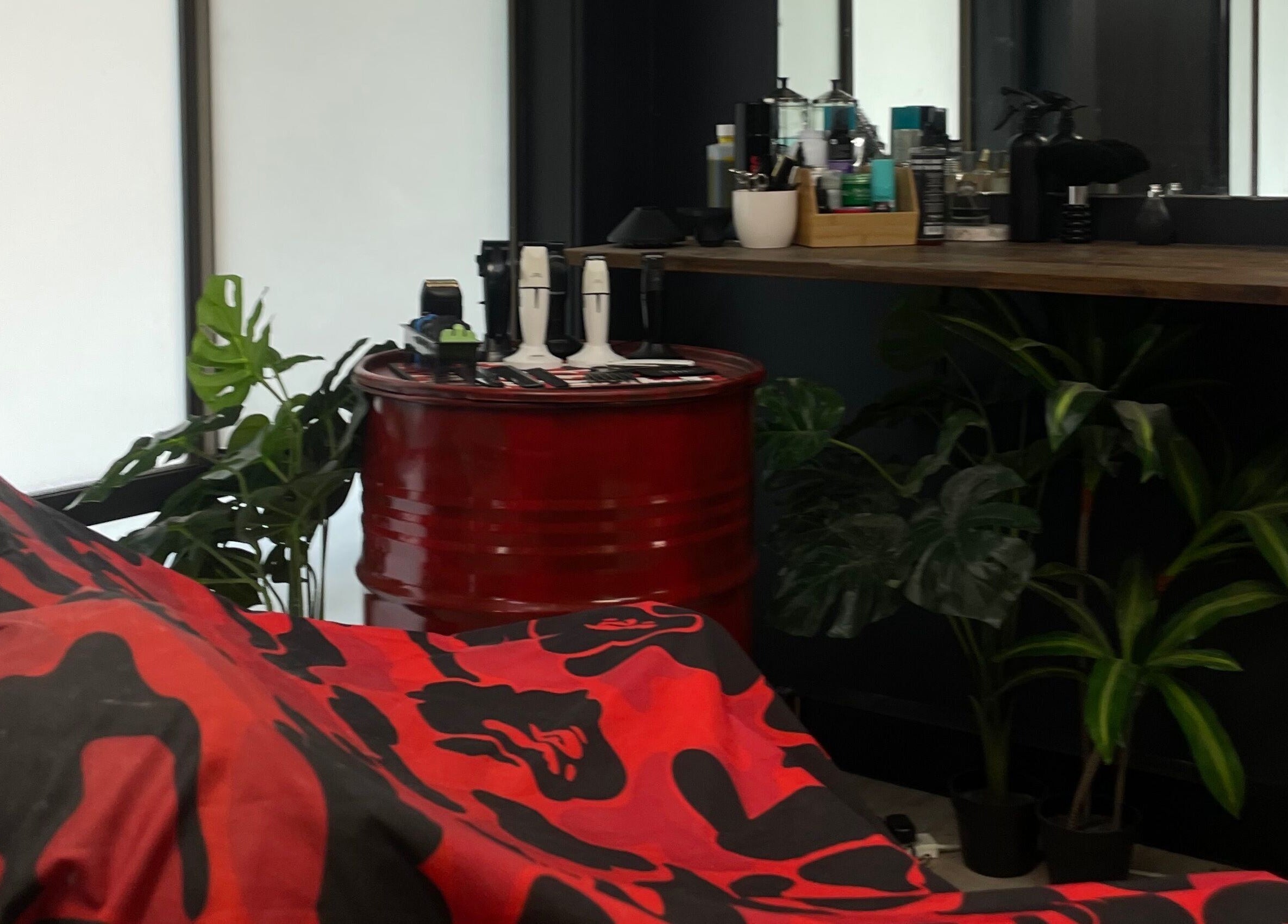 Chic barber setup at Engineroom Barbers, Fountaindale, New South Wales, AU with tools and plants.