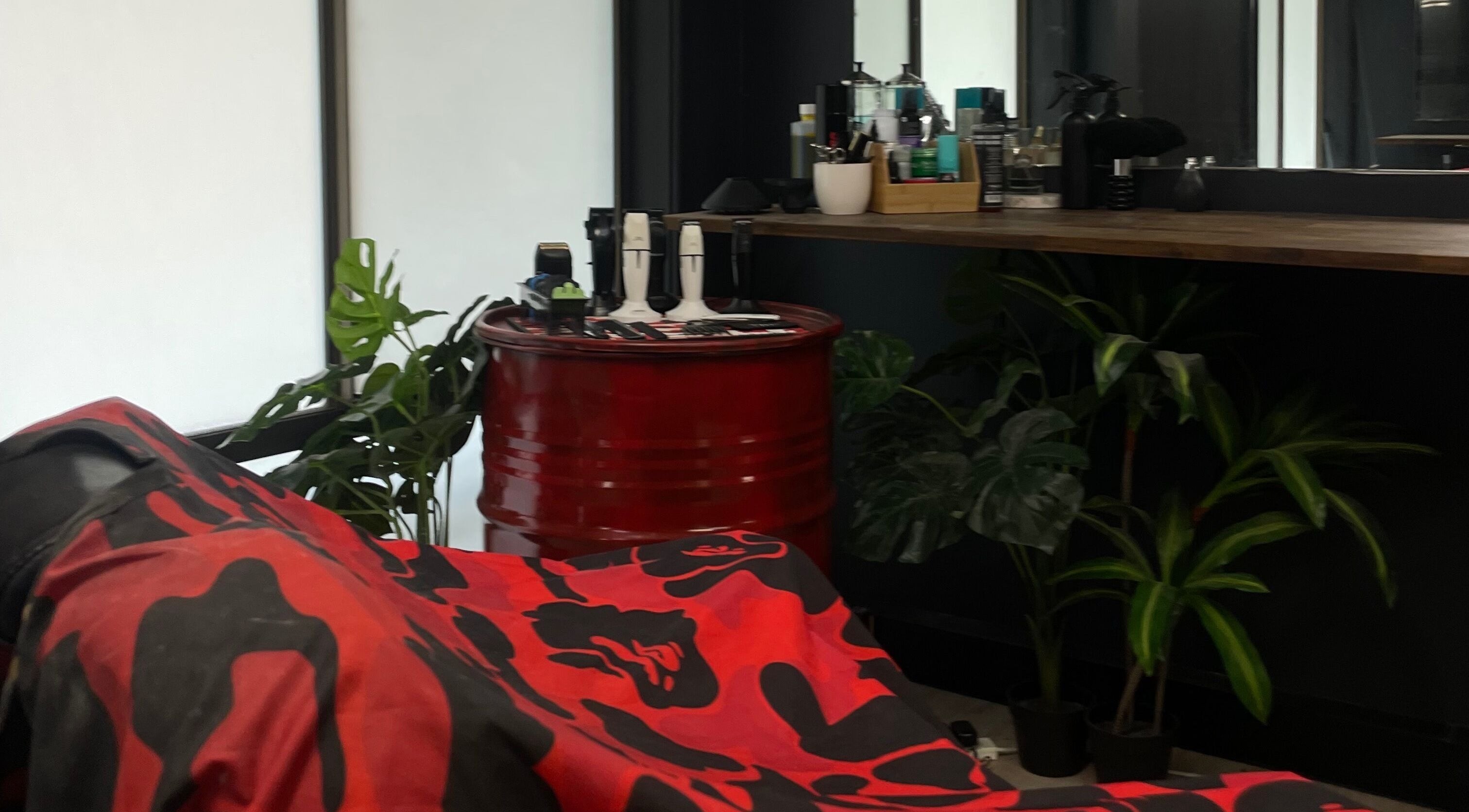 Chic barber setup at Engineroom Barbers, Fountaindale, New South Wales, AU with tools and plants.