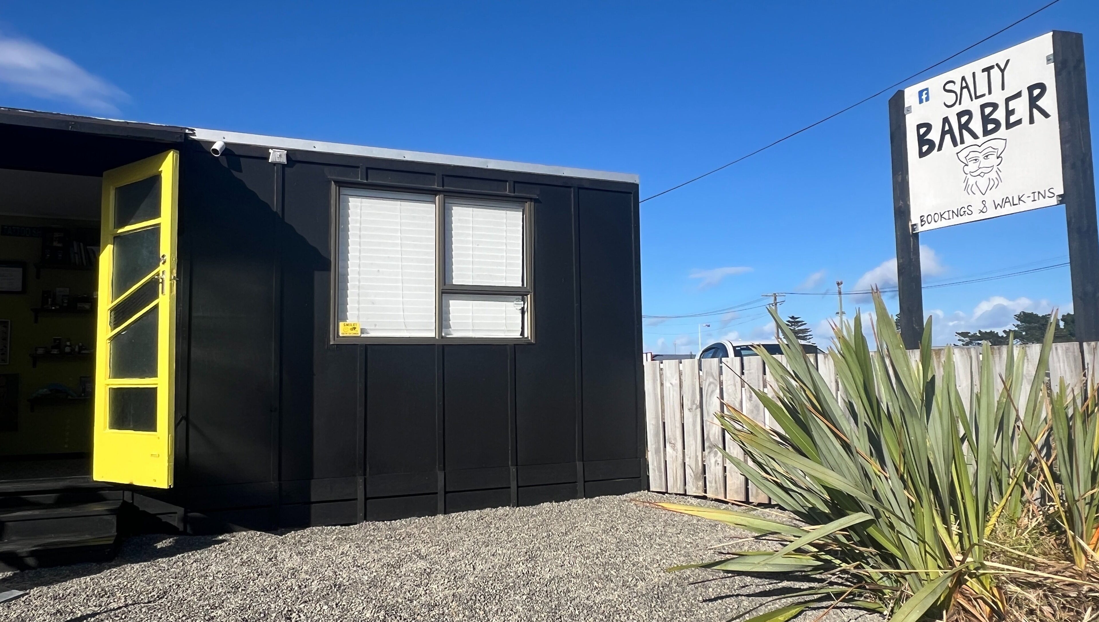 Entrance view of The Salty Barber, located in Manawatū-whanganui, Manawatū-whanganui, NZ on a sunny day.