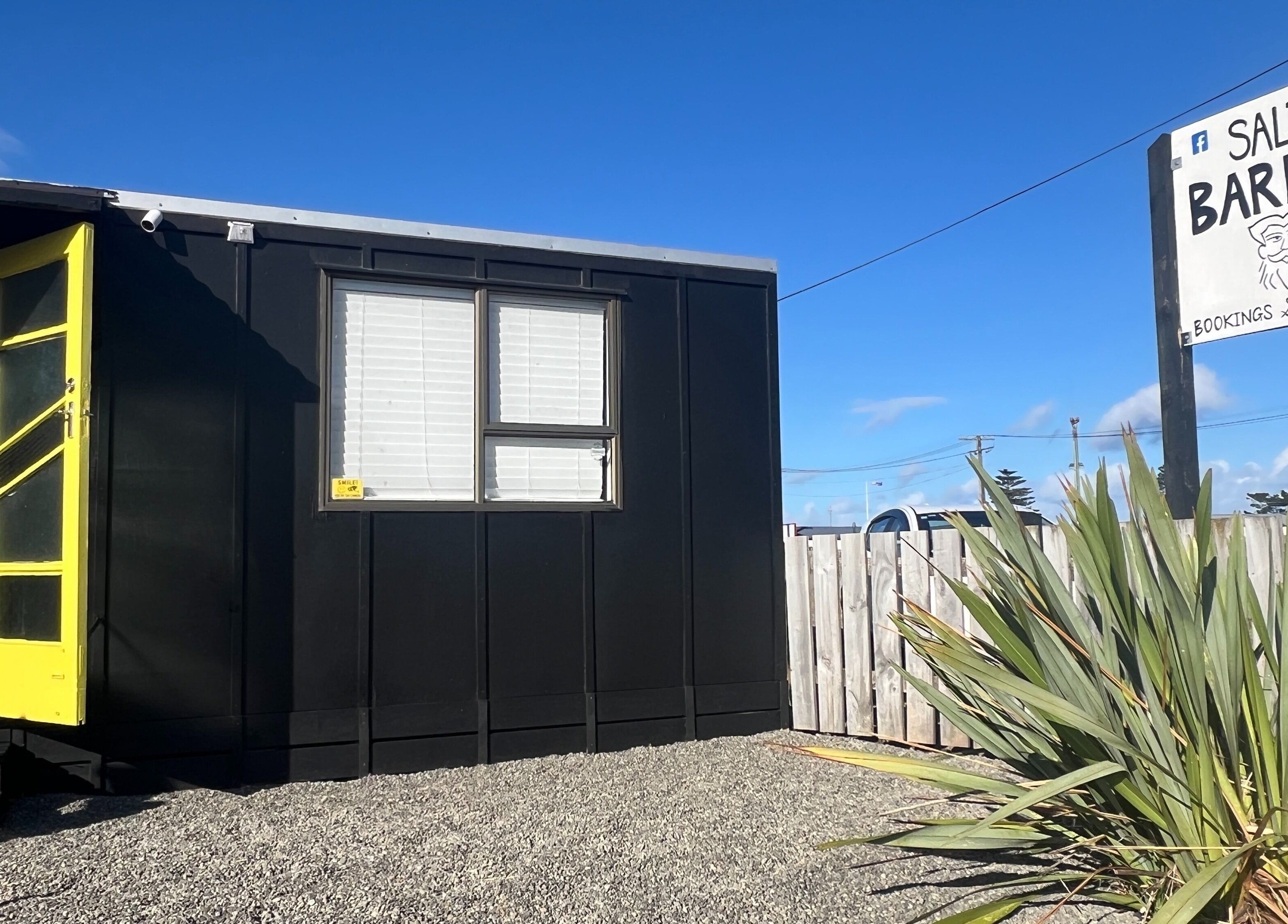 Entrance view of The Salty Barber, located in Manawatū-whanganui, Manawatū-whanganui, NZ on a sunny day.