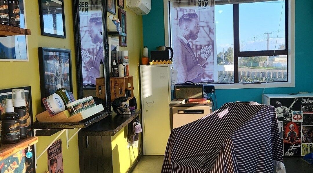 Inside The Salty Barber in Manawatū-whanganui, NZ, showcasing stylish barber chair and grooming products.