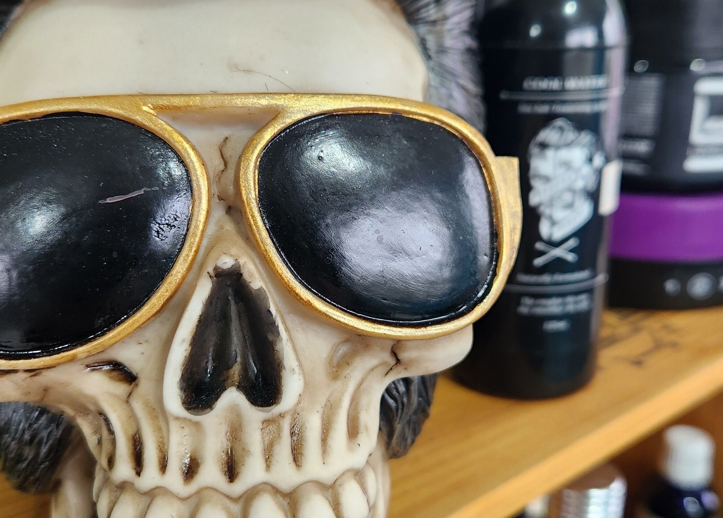 Skull decor with sunglasses at The Salty Barber, Manawatū-whanganui, NZ, showcasing edgy salon style.
