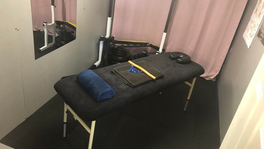 Therapy room at A.S. Sports Therapist, Cramlington, England, GB with massage table and soothing decor.