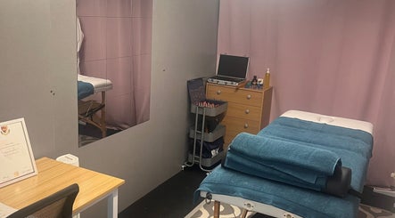 Therapy room at A.S.Sports Therapist, Cramlington, England, GB with massage table and relaxation setup.
