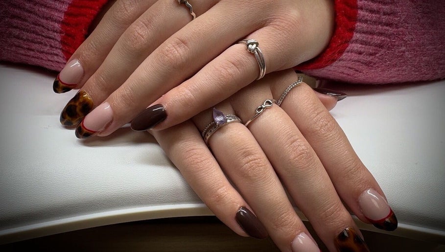 Stylish nail design at Nail Envy in Weymouth, England, GB, featuring trendy brown and tortoise shell patterns.
