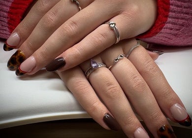 Stylish nail design at Nail Envy in Weymouth, England, GB, featuring trendy brown and tortoise shell patterns.