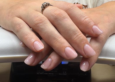 Elegant manicured hands with a ring at Nail Envy, Weymouth, England, GB.