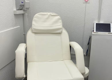 A plush white spa chair in a serene room at Divine Line Tattoo, Newquay, England, GB.