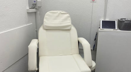 A plush white spa chair in a serene room at Divine Line Tattoo, Newquay, England, GB.