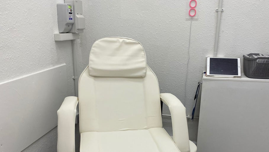 Comfortable white spa chair at Divine Line Tattoo, Newquay, England, GB. Perfect for relaxation and wellness.