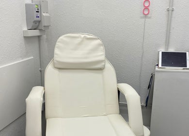 Comfortable white spa chair at Divine Line Tattoo, Newquay, England, GB. Perfect for relaxation and wellness.