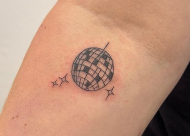 Tattoo of a disco ball with sparkles at Divine Line Tattoo, Newquay, England, GB.