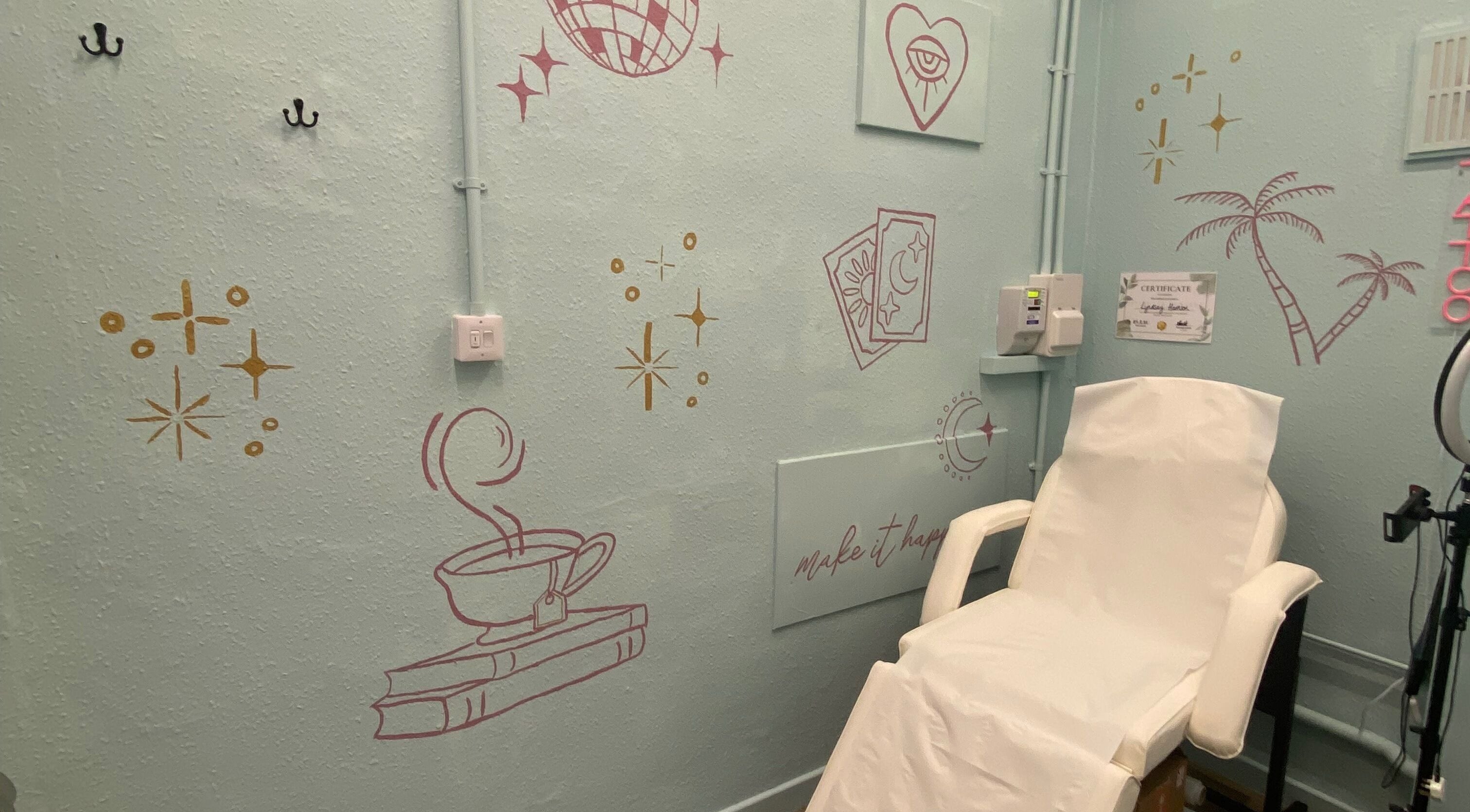 Cozy tattoo room at Divine Line Tattoo in Newquay, England, GB with artistic wall decor and a comfortable chair.
