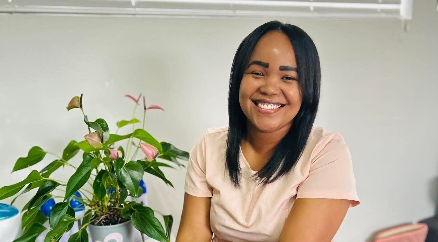 Smiling staff at Aspire Beauty Studio, Jeffreys Bay, Eastern Cape, ZA with indoor plant decor.