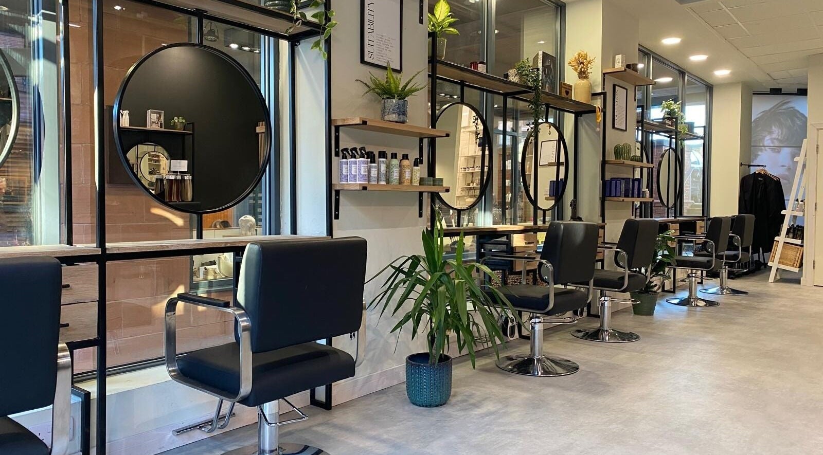 Elegant interior of Benny & Co. Hair Studios, Knutsford, England, GB featuring stylish decor and seating.