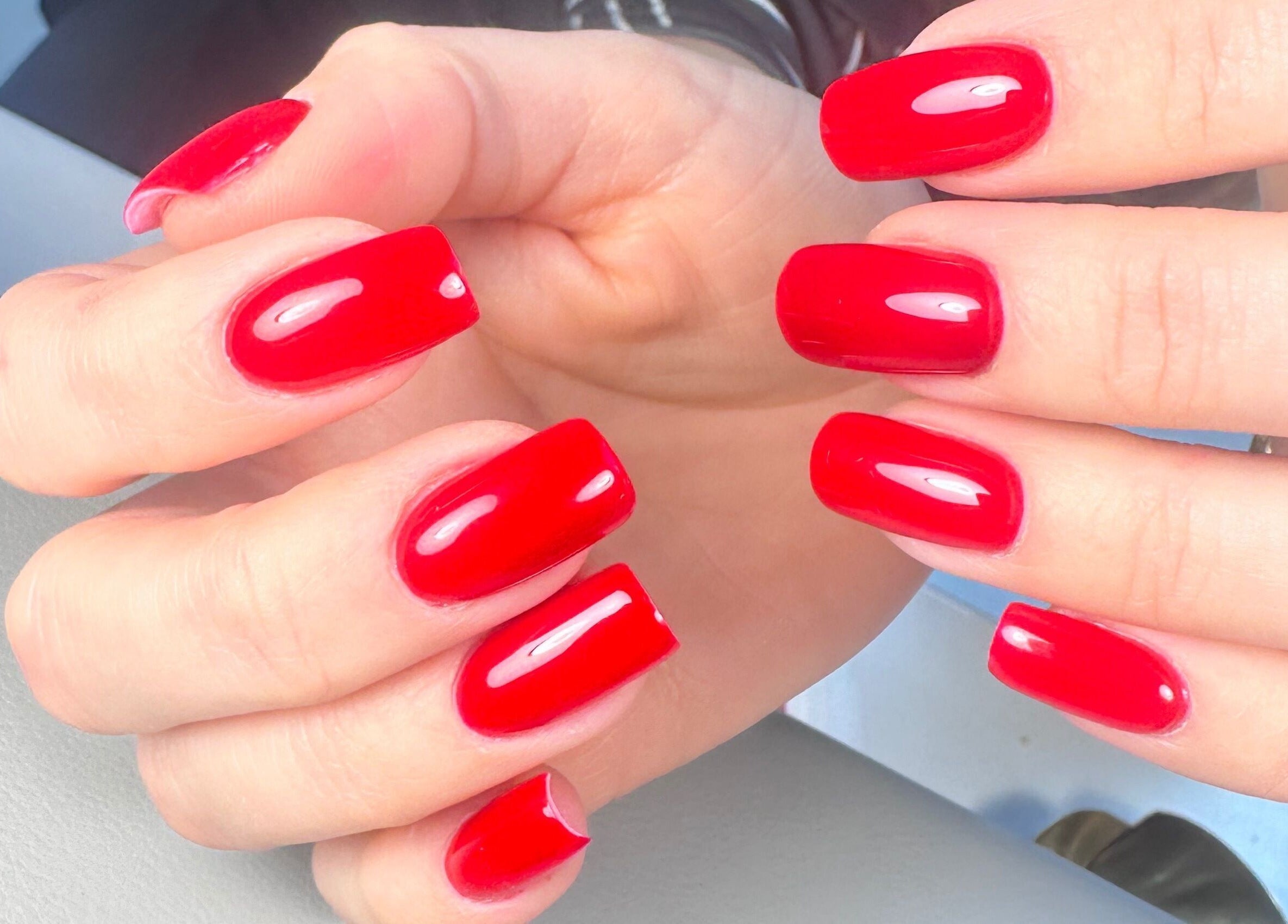 Vibrant red nails in a modern style at Nails by Azi, Royal Leamington Spa, England, GB.