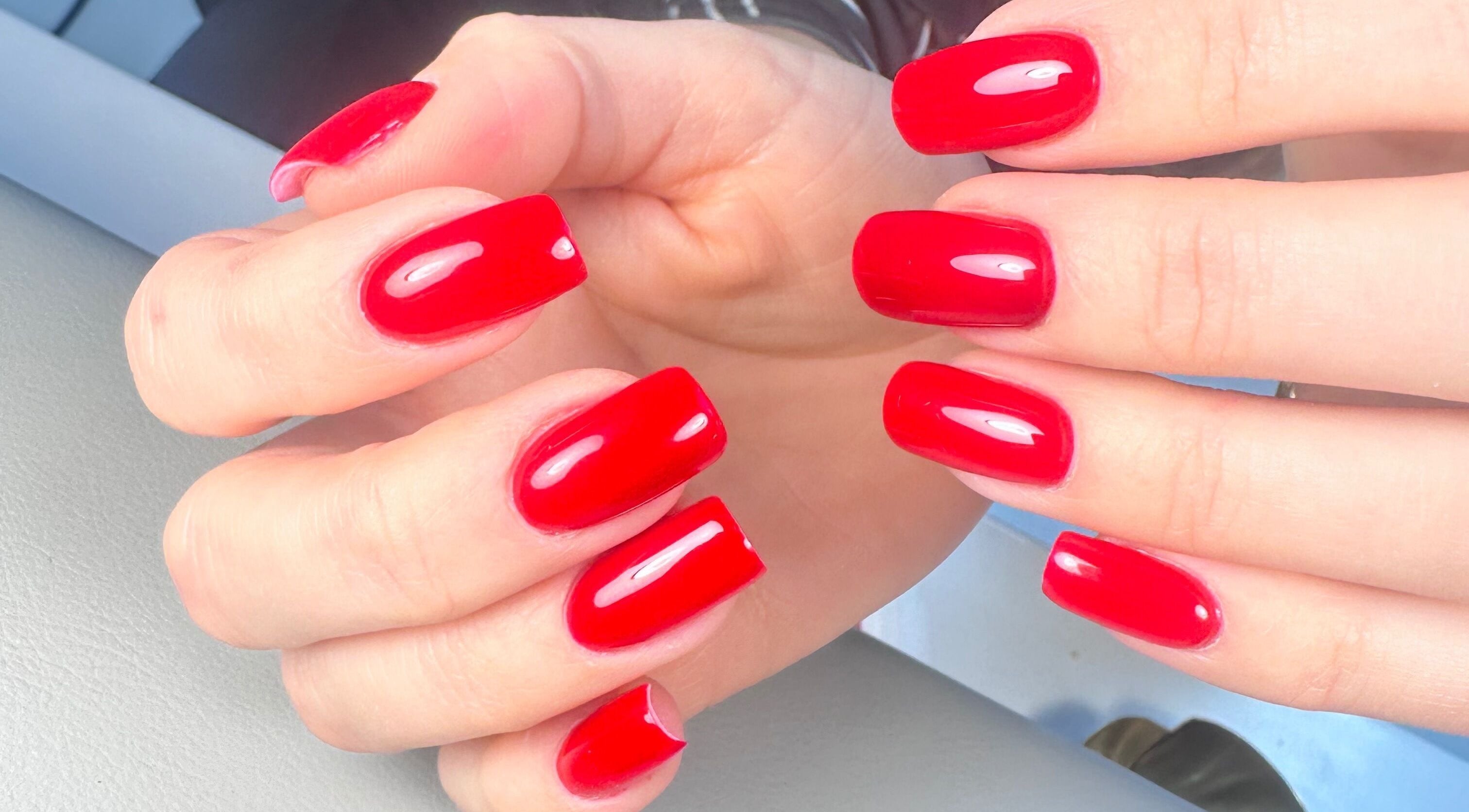 Vibrant red nails in a modern style at Nails by Azi, Royal Leamington Spa, England, GB.