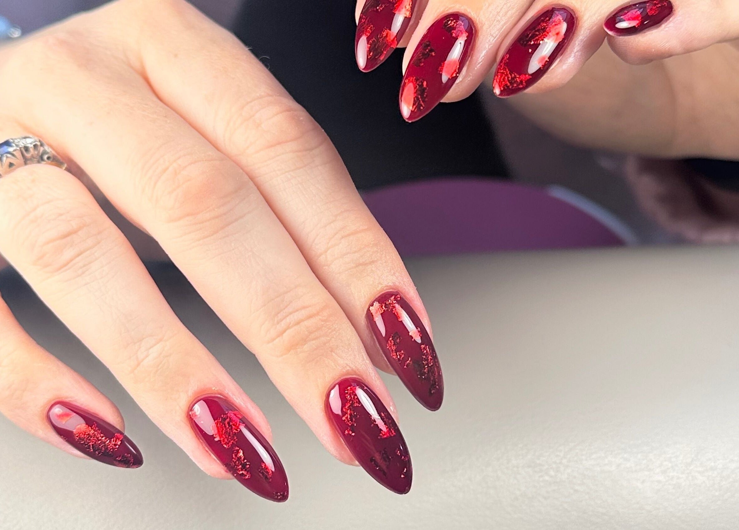 Gorgeous crimson nails with intricate design at Nails by Azi, Royal Leamington Spa, England, GB.