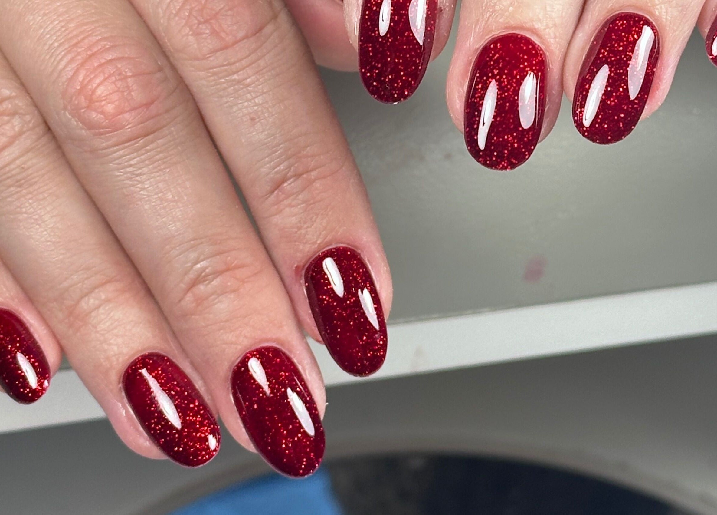 Elegant red glitter nails at Nails by Azi, Royal Leamington Spa, England, GB.