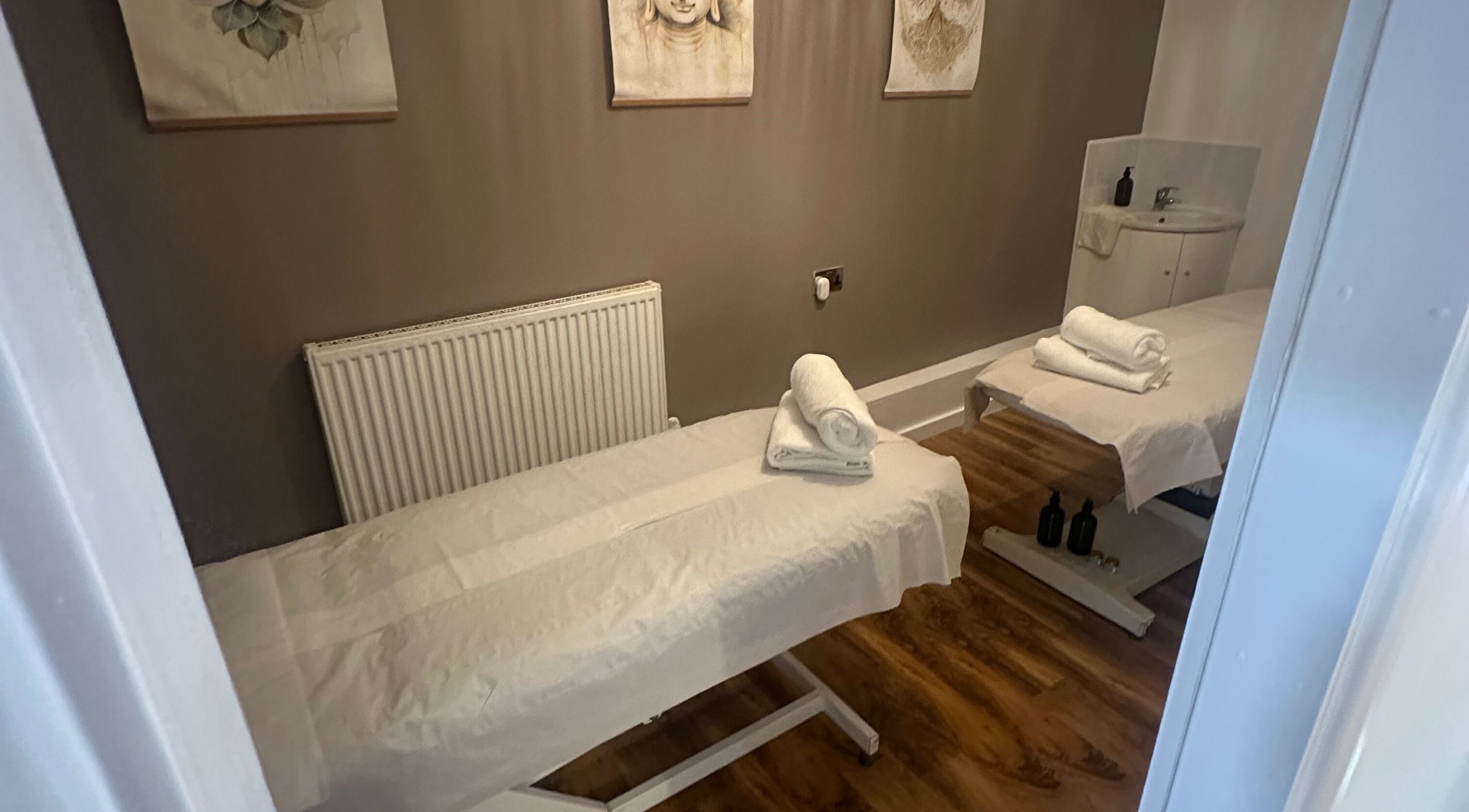 Calm massage room at Khamsaen Thai massage, London, England, GB, featuring two treatment beds.
