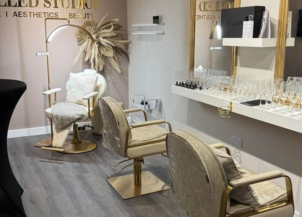 Chic interior of Dolled Studios in Clipstone, England. Stylish chairs with gold accents and sleek decor.