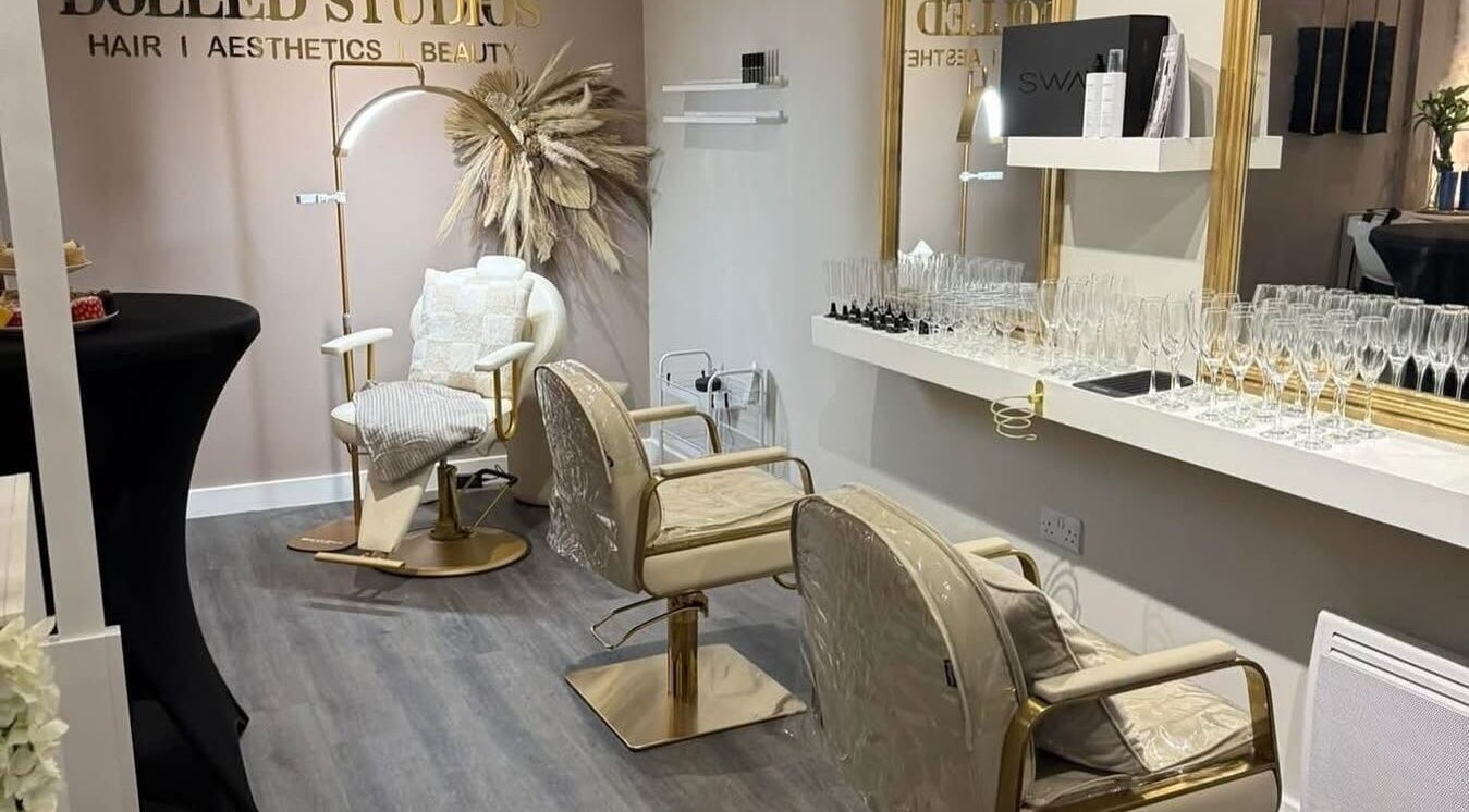 Chic interior of Dolled Studios in Clipstone, England. Stylish chairs with gold accents and sleek decor.