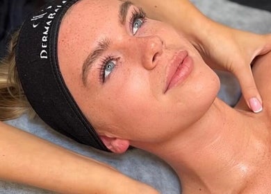 Relaxed woman enjoying a facial at Derma Balance, Royal Tunbridge Wells, England, GB.