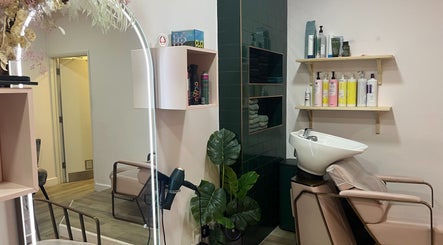 Modern wash station at Jenny's Hair Design in Warfield, England, GB, with products on display.