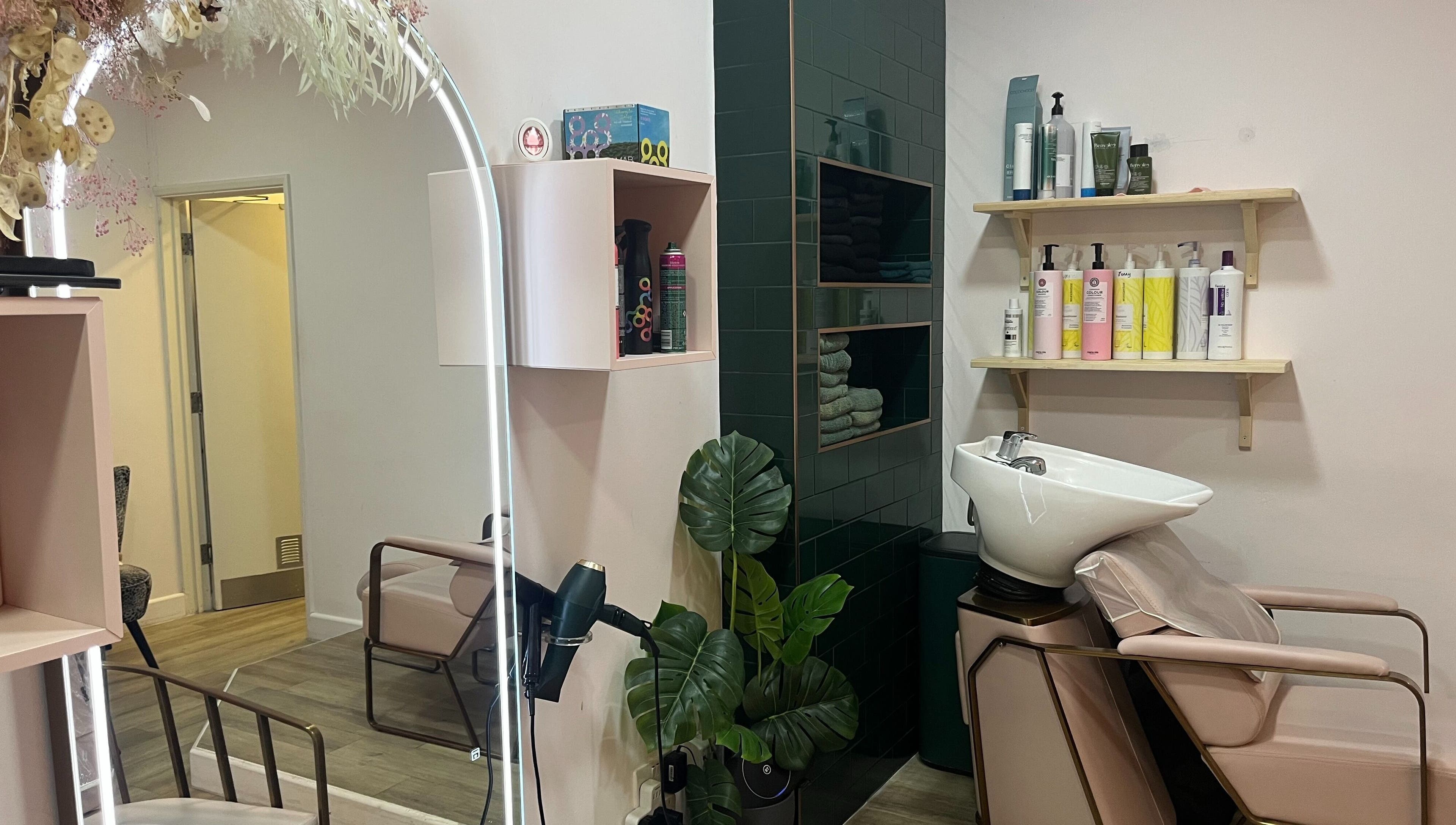 Jenny's Hair Design in Warfield, England offers a modern salon interior with styling chairs and a wash basin.