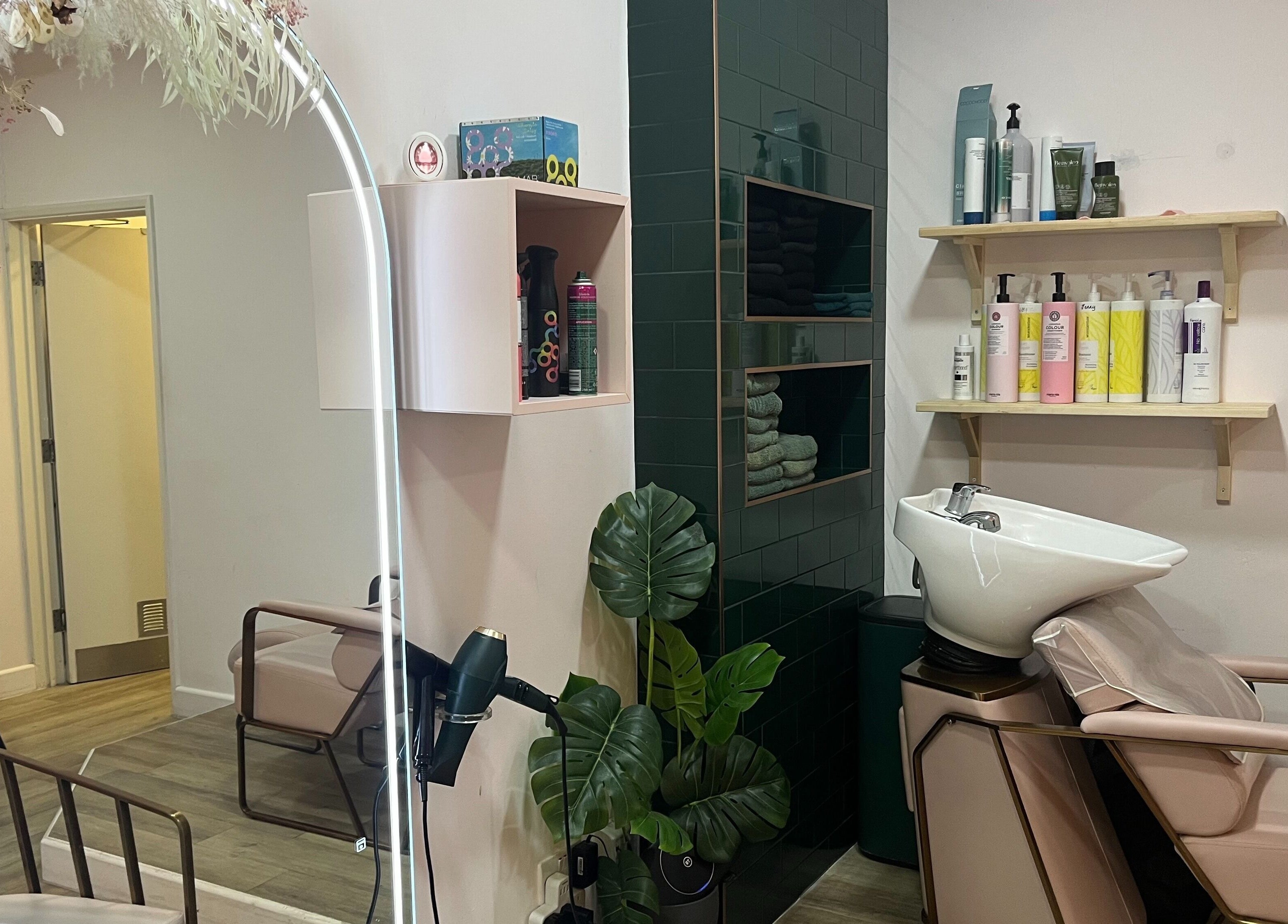 Jenny's Hair Design in Warfield, England offers a modern salon interior with styling chairs and a wash basin.
