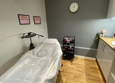 Cozy treatment room at Emma’s Beauty Room, Morpeth, England, GB, featuring a massage table and essential products.
