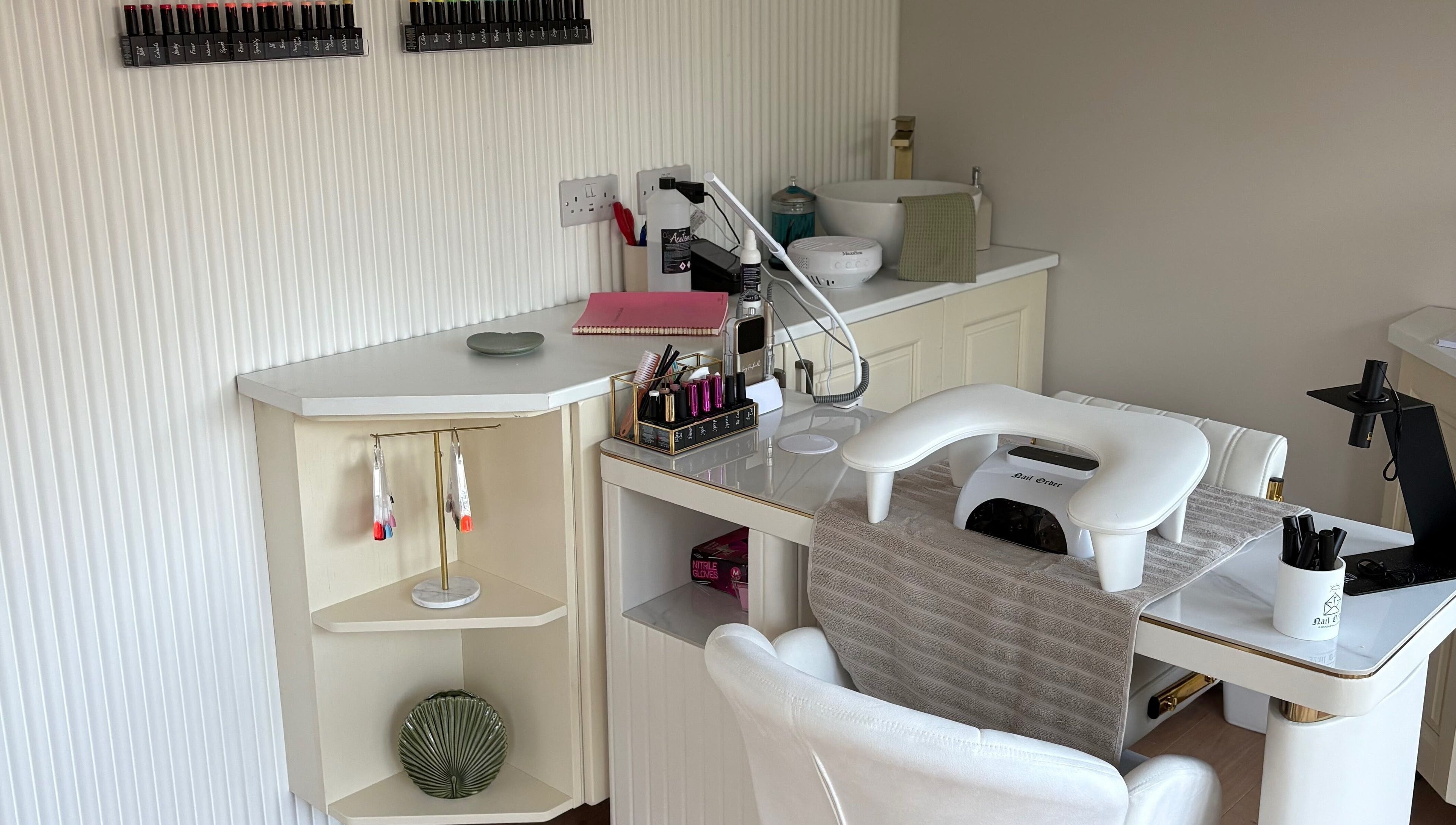 Elegant nail station at The Forge Beauty Room, Newsham, England, GB, showcasing tools and polish selection.