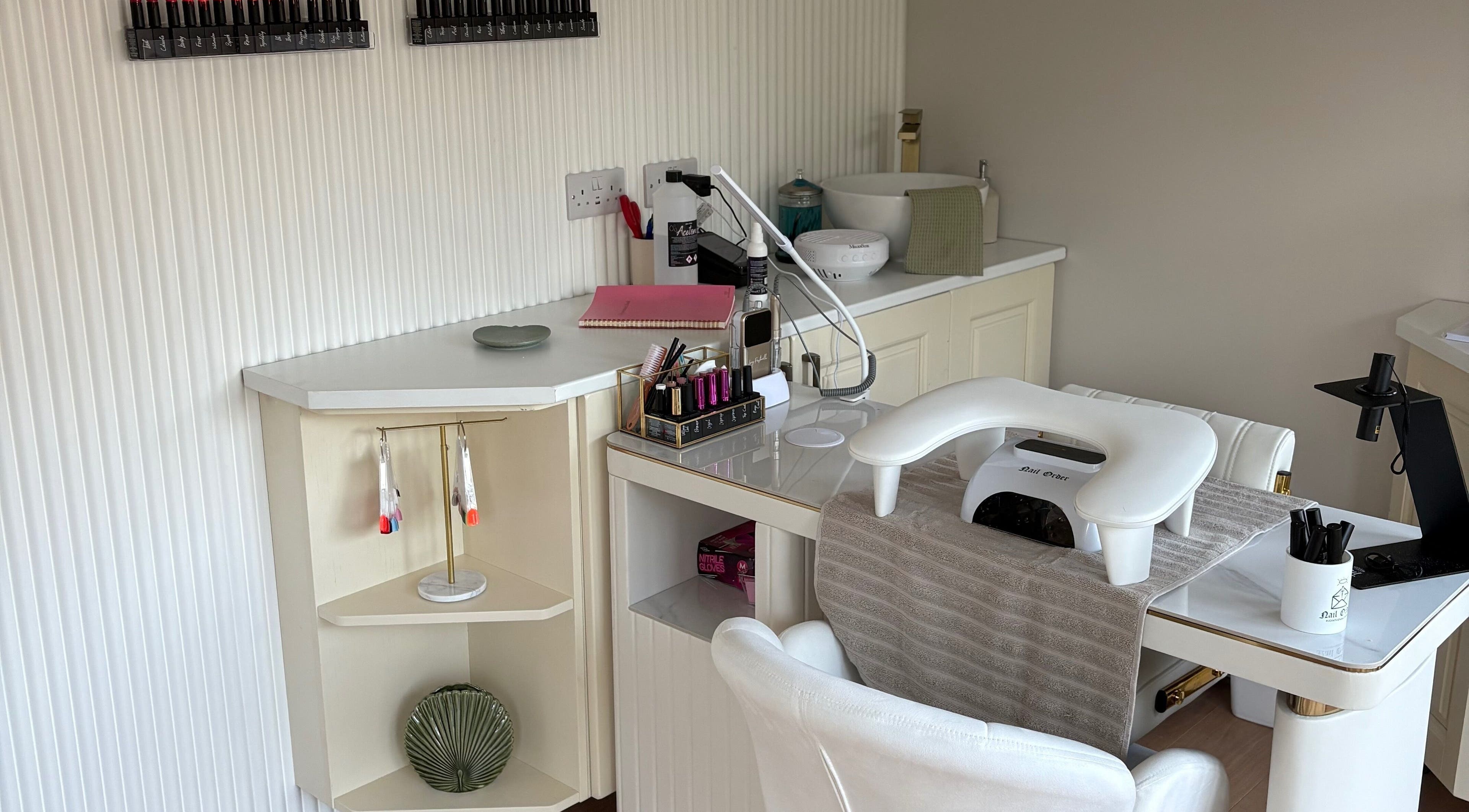Elegant nail station at The Forge Beauty Room, Newsham, England, GB, showcasing tools and polish selection.