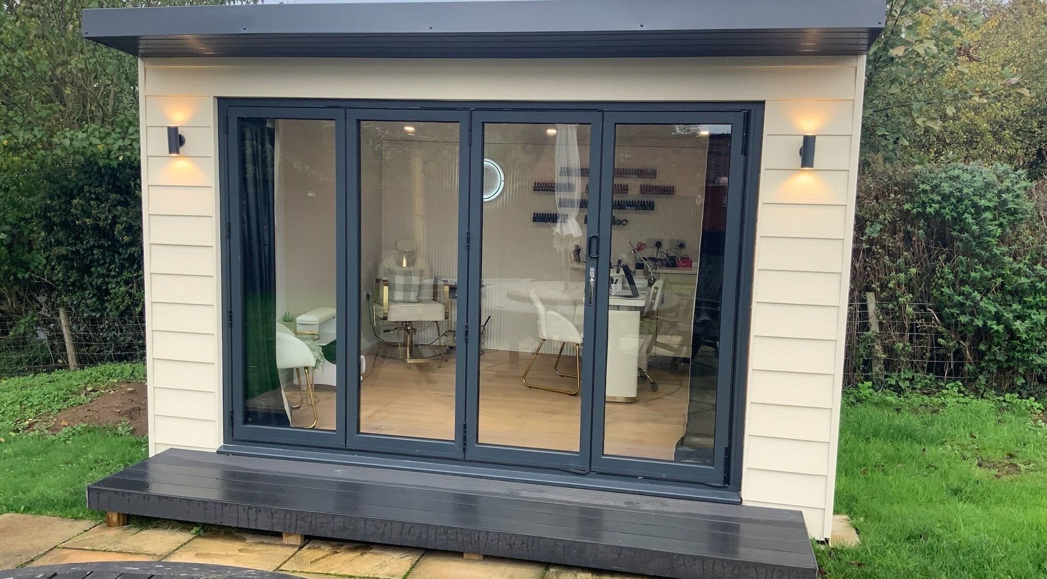 The Forge Beauty Room in Newsham, England showcases a modern, inviting exterior with large glass doors.