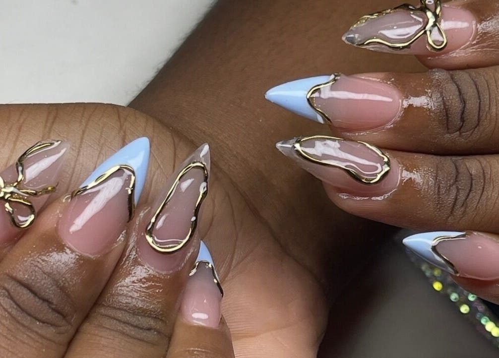 Elegant nail art at Brittz Nailz, Mandeville, Manchester Parish, JM with gold accents and blue tips.