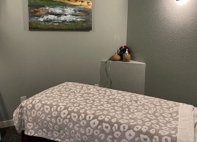 Cozy massage room at Su Microblading & Wellness Massage in Parker, Colorado, US with comfy bed and soothing decor.