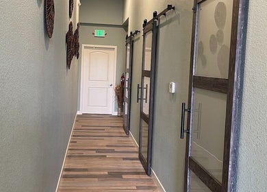 Hallway with wooden doors at Su Microblading & Wellness Massage, Parker, Colorado, US.