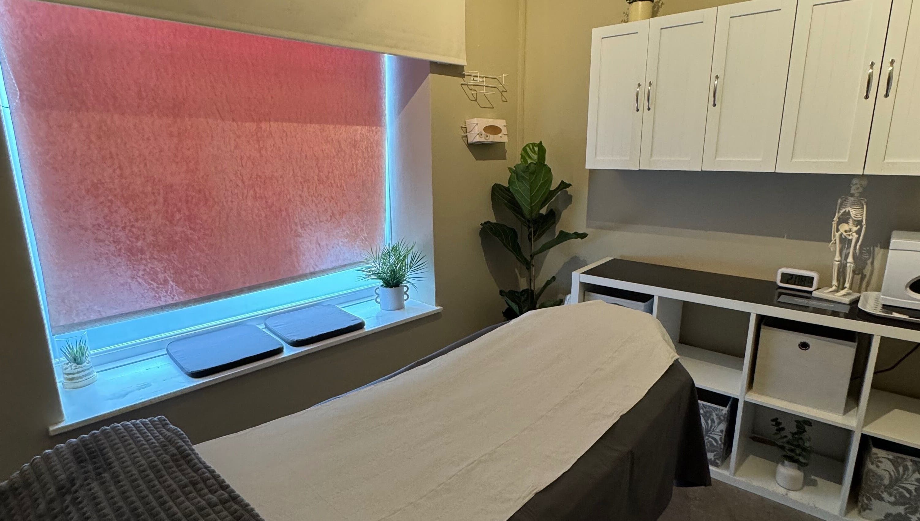 Peaceful therapy room at New Motion Sports Therapy, Bude, England, GB, with a cozy massage table and calming decor.