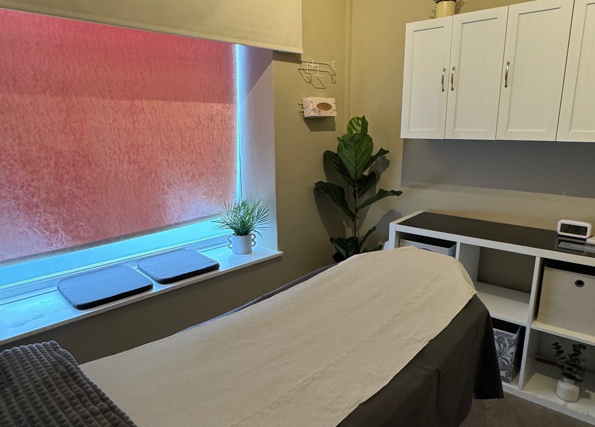 Peaceful therapy room at New Motion Sports Therapy, Bude, England, GB, with a cozy massage table and calming decor.