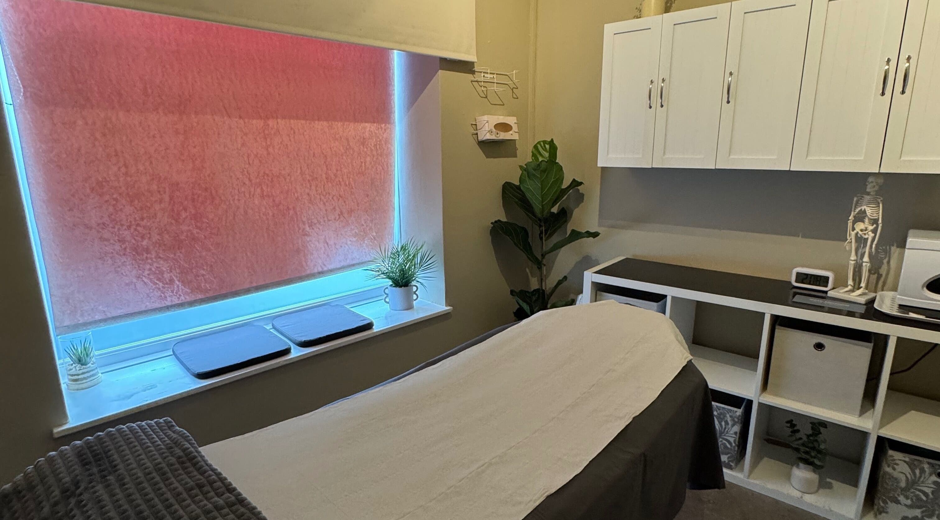 Peaceful therapy room at New Motion Sports Therapy, Bude, England, GB, with a cozy massage table and calming decor.