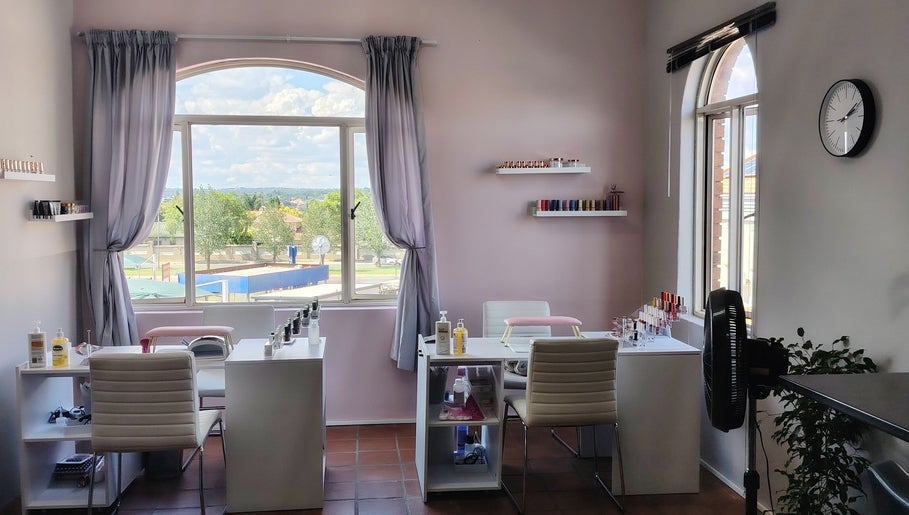 Bright nail salon interior at Prim Nails Skin Hair, Pretoria, Gauteng, ZA with nail polish shelves and seating.