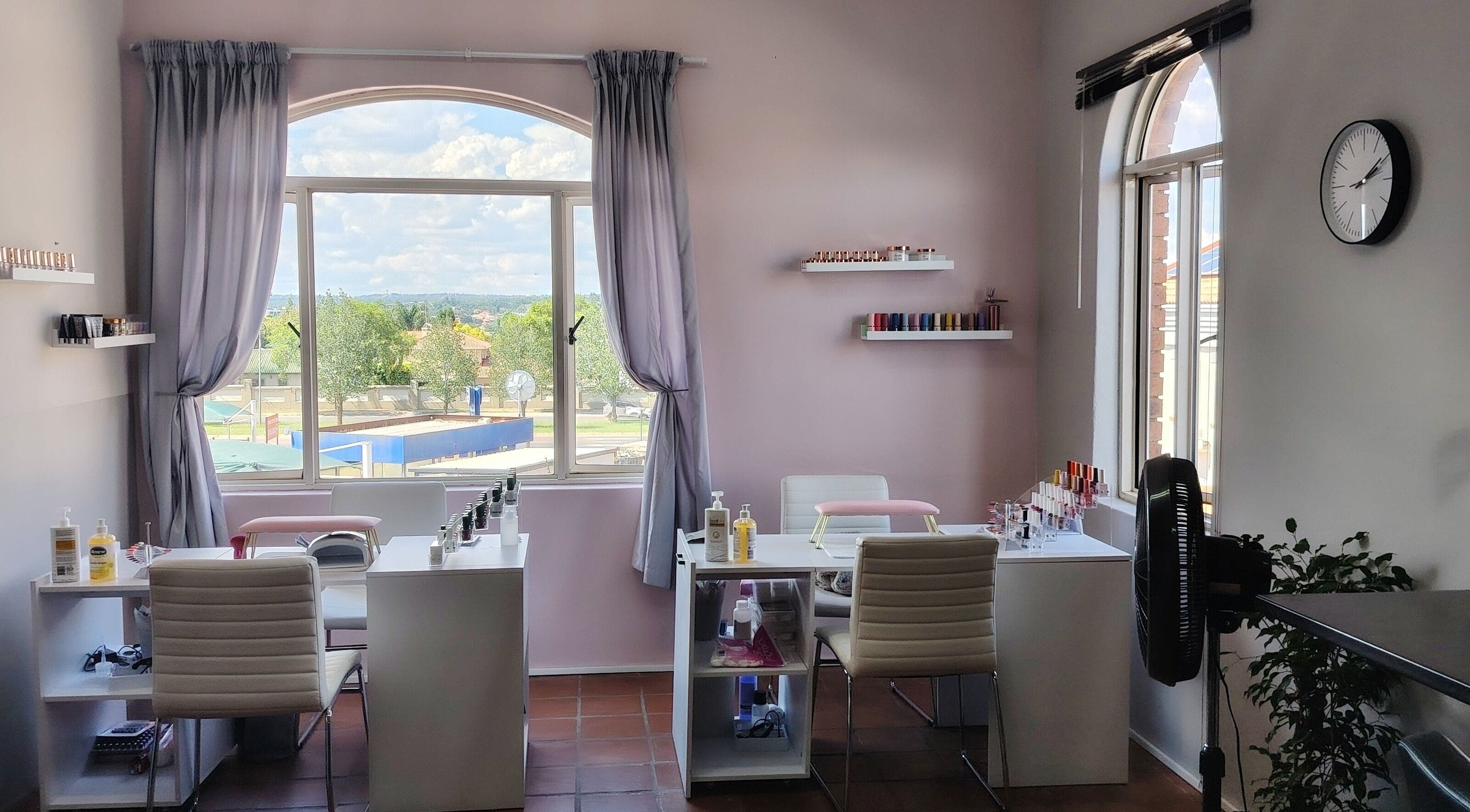 Bright nail salon interior at Prim Nails Skin Hair, Pretoria, Gauteng, ZA with nail polish shelves and seating.