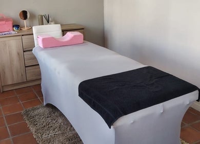 Spa treatment room at Prim Nails Skin Hair in Pretoria, Gauteng, ZA, featuring a massage table and serene decor.