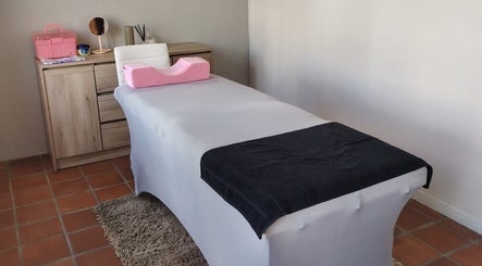Spa treatment room at Prim Nails Skin Hair in Pretoria, Gauteng, ZA, featuring a massage table and serene decor.