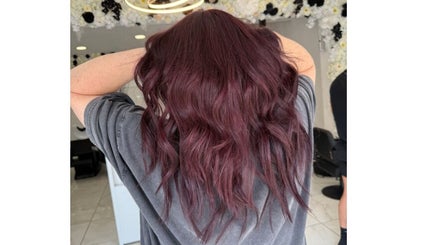 Burgundy wavy hair styled at Shelbi Halewood Hair in Prestwich, England, GB.