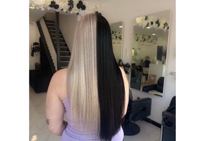 Split hair style at Shelbi Halewood Hair in Prestwich, England, GB salon with black and blonde colors.